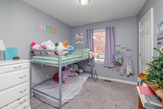 bedroom featuring light carpet and baseboards