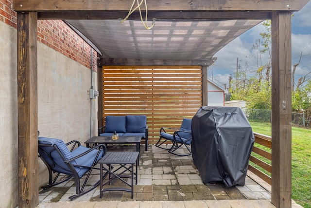 view of patio with a grill, fence, and outdoor lounge area