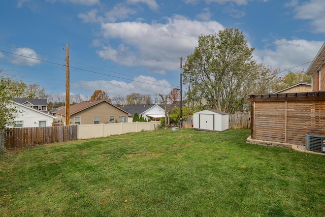 view of yard featuring a shed, an outdoor structure, and a residential view
