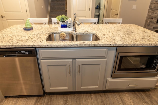 528 Old Station Rd, Frankfort, KY 40601 - kitchen with appliances with stainless steel finishes, wood finished floors, light stone countertops, and gray cabinetry