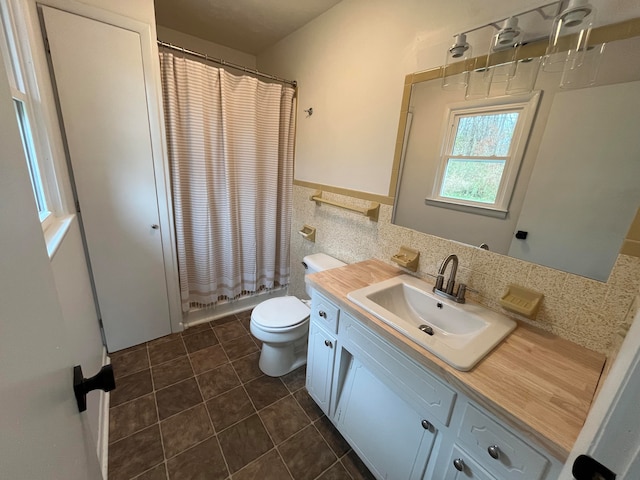 full bathroom with vanity, tile patterned flooring, toilet, shower / bath combo with shower curtain, and tasteful backsplash