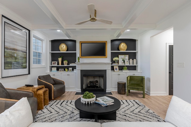 living room with beamed ceiling, built in shelves, and light wood-type flooring