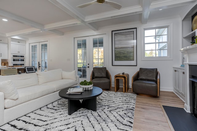 living room featuring french doors, beamed ceiling, coffered ceiling, and light hardwood / wood-style flooring