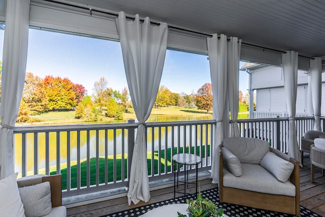 sunroom / solarium featuring a water view and a wealth of natural light