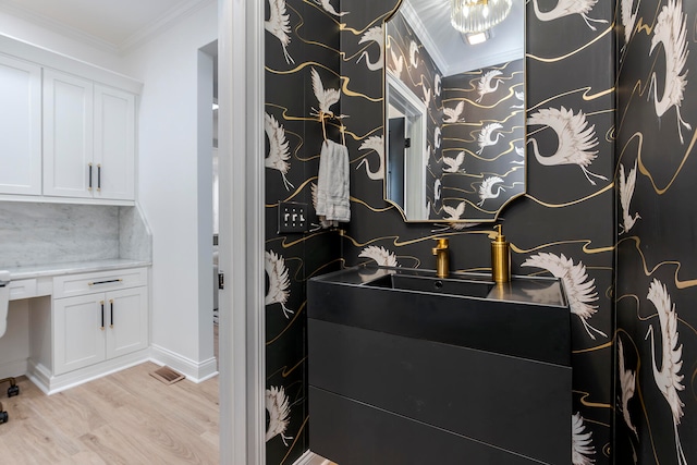 bathroom with vanity, hardwood / wood-style flooring, tasteful backsplash, and crown molding