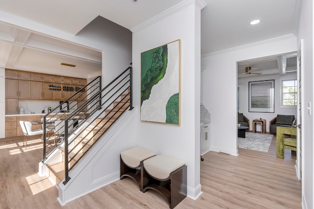 stairway featuring hardwood / wood-style flooring, beam ceiling, ornamental molding, and coffered ceiling