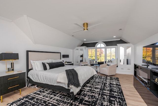 bedroom with ceiling fan, lofted ceiling, and hardwood / wood-style flooring