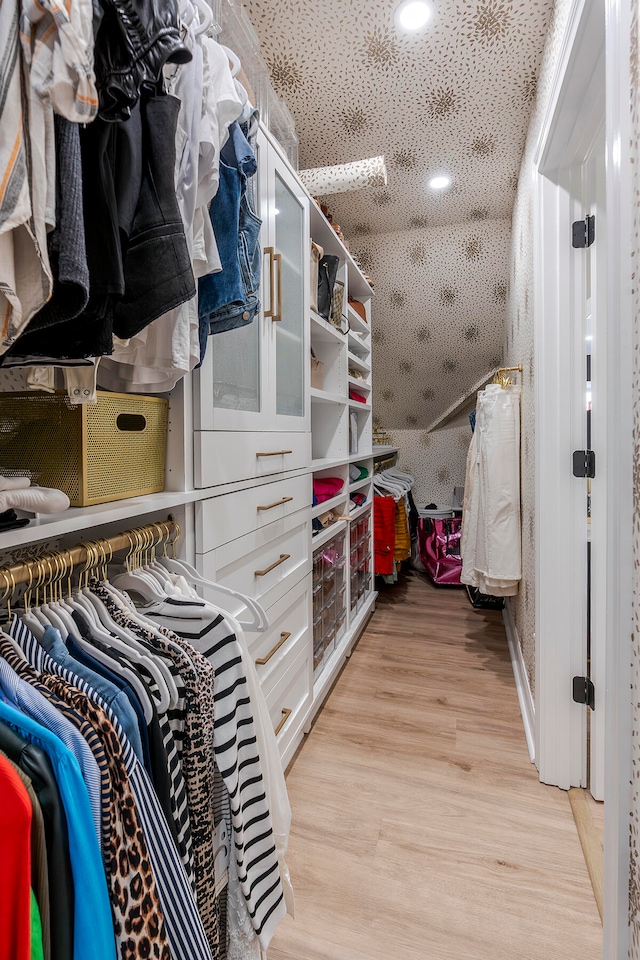 spacious closet featuring light hardwood / wood-style flooring