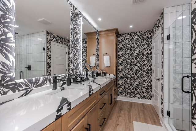 bathroom featuring vanity, hardwood / wood-style flooring, and an enclosed shower