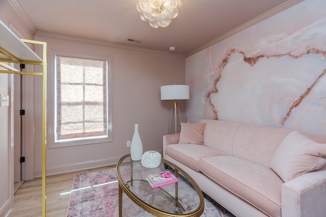 living room featuring light hardwood / wood-style flooring, crown molding, and a notable chandelier