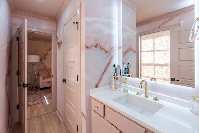 bathroom with hardwood / wood-style flooring, vanity, and crown molding