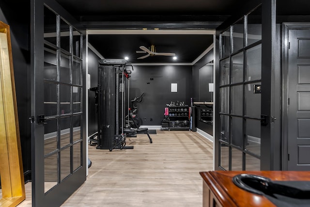 workout room with french doors, hardwood / wood-style flooring, ceiling fan, and ornamental molding