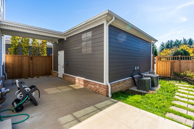 view of side of home featuring a patio area and central AC unit