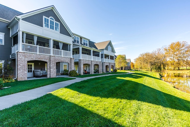 multi unit property featuring outdoor lounge area, a water view, a balcony, and a front yard