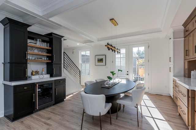 dining area featuring coffered ceiling, french doors, crown molding, wine cooler, and light wood-type flooring