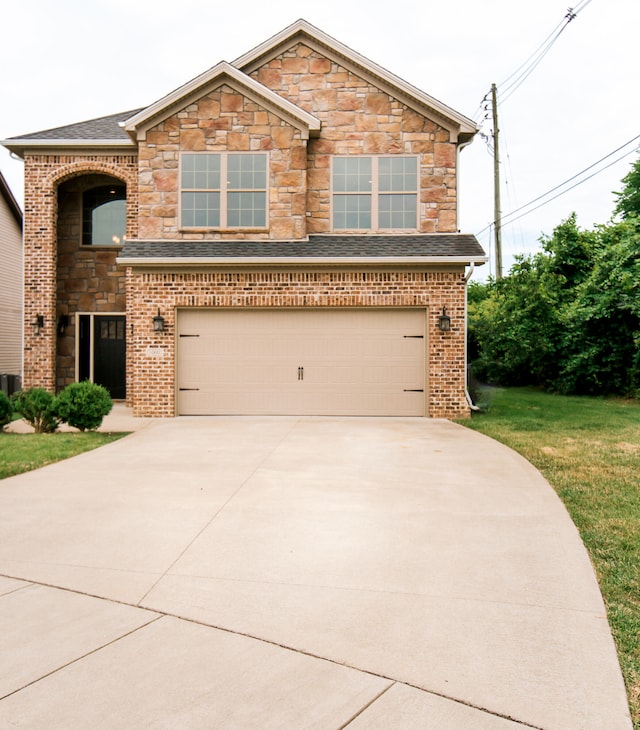 view of front of house featuring a garage and a front lawn