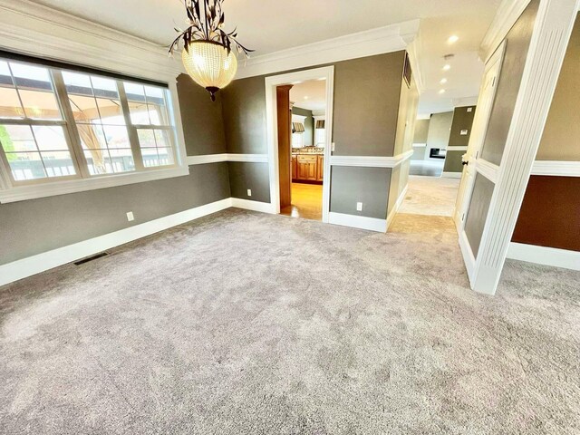 kitchen with crown molding, light stone counters, light hardwood / wood-style flooring, and stainless steel appliances