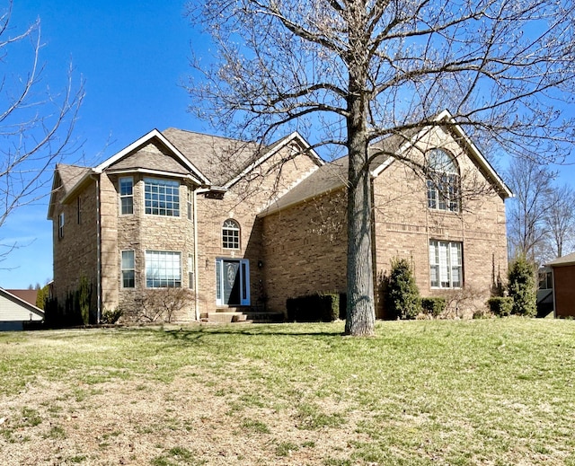 view of front of house featuring a front lawn and stone siding