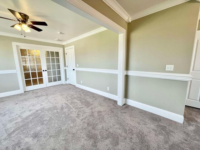 empty room with crown molding, carpet floors, and ceiling fan