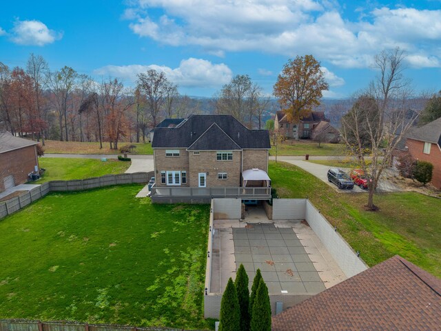 back of house with a gazebo, a yard, and a wooden deck