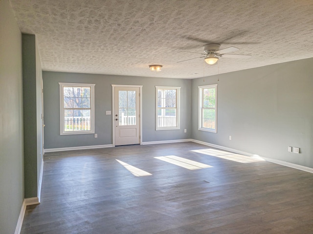 spare room featuring ceiling fan and dark wood-type flooring