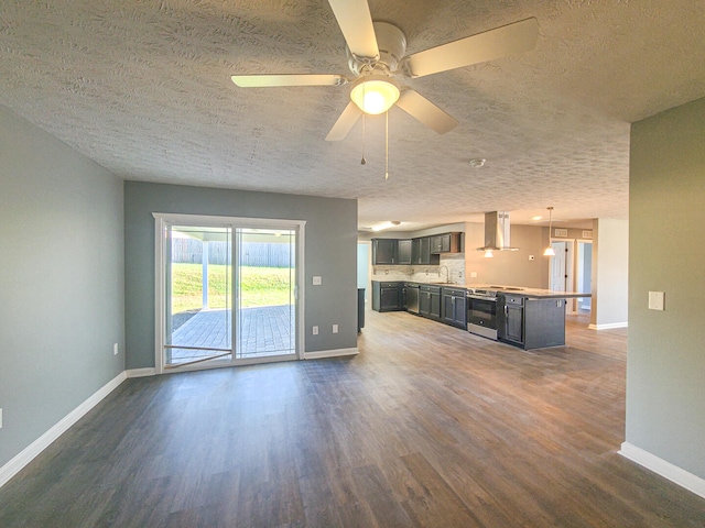 unfurnished living room featuring ceiling fan, dark hardwood / wood-style flooring, a textured ceiling, and sink