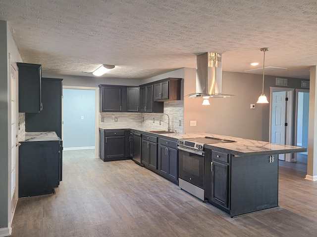 kitchen with sink, wall chimney exhaust hood, a kitchen breakfast bar, light hardwood / wood-style flooring, and stainless steel range with electric cooktop