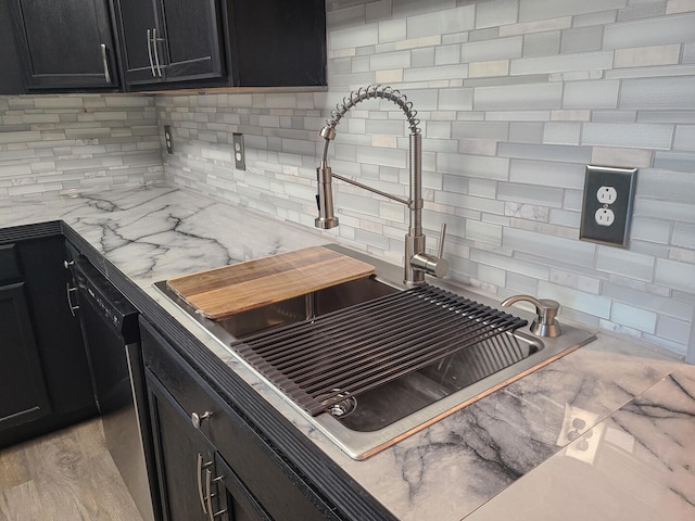 room details featuring decorative backsplash, sink, dishwasher, and light hardwood / wood-style flooring