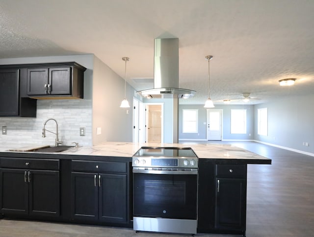 kitchen featuring stainless steel electric stove, sink, ceiling fan, a textured ceiling, and island exhaust hood