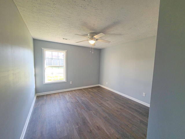 spare room featuring a textured ceiling, ceiling fan, and dark hardwood / wood-style floors