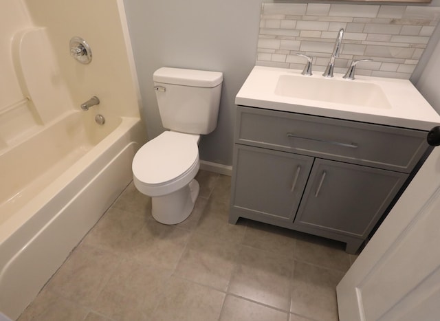 full bathroom with vanity, tile patterned floors, toilet, decorative backsplash, and shower / bathing tub combination