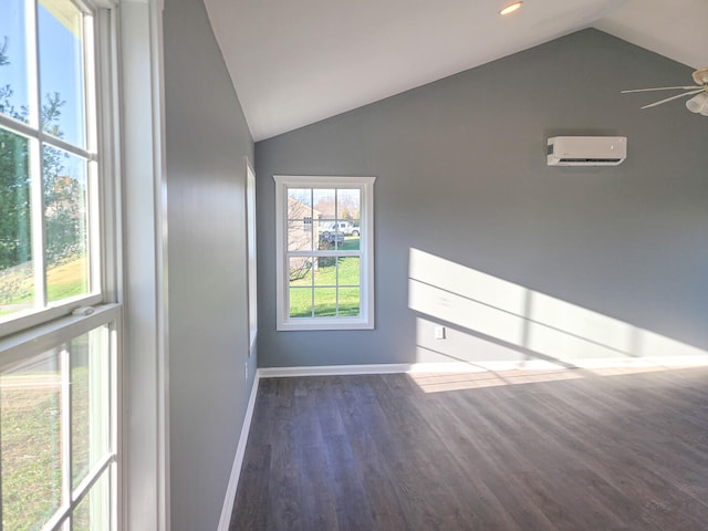 unfurnished room featuring dark hardwood / wood-style floors, vaulted ceiling, ceiling fan, and a wall mounted AC