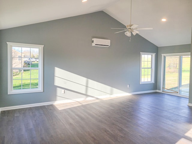 empty room with dark hardwood / wood-style flooring, lofted ceiling, and a wealth of natural light