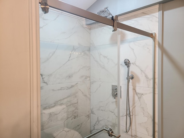 bathroom with a shower with shower door