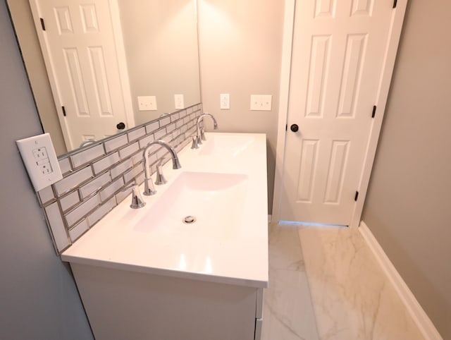 bathroom with decorative backsplash and vanity