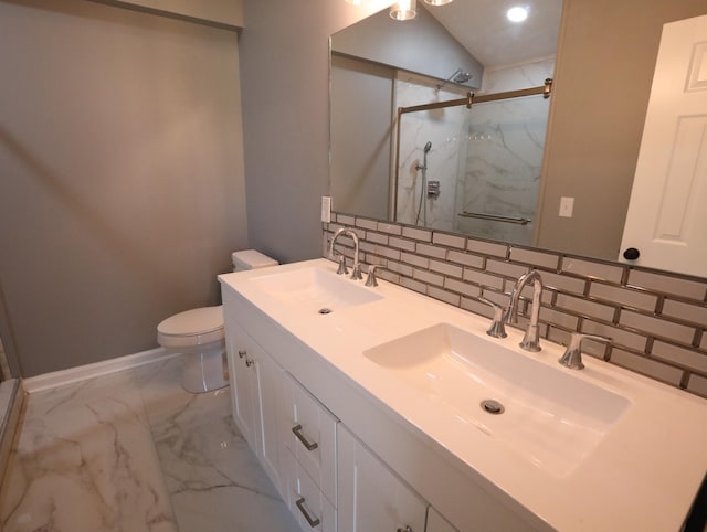 bathroom featuring backsplash, vanity, a shower with shower door, and toilet