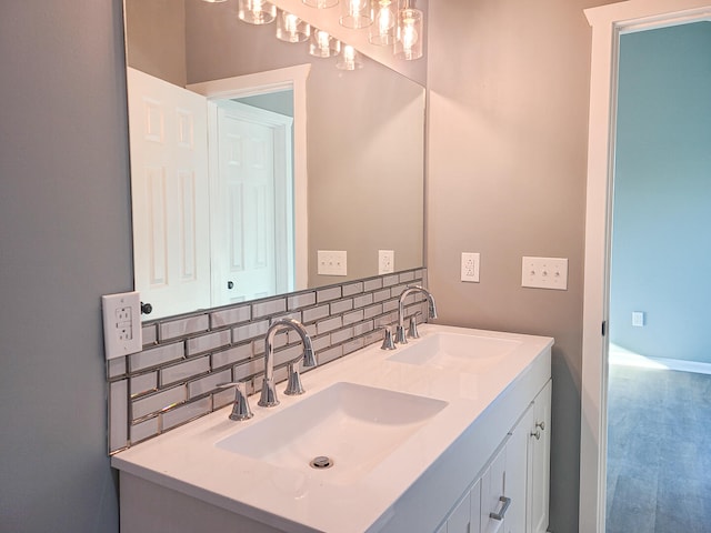 bathroom with decorative backsplash and vanity