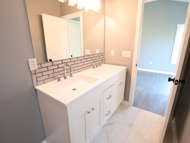 bathroom with vanity and tasteful backsplash