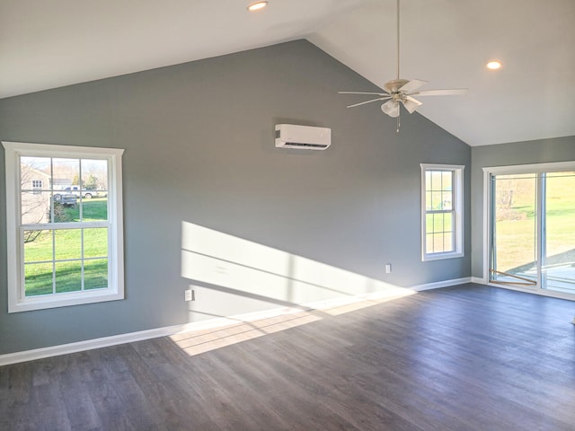 unfurnished room featuring ceiling fan, dark hardwood / wood-style flooring, a wealth of natural light, and a wall mounted AC