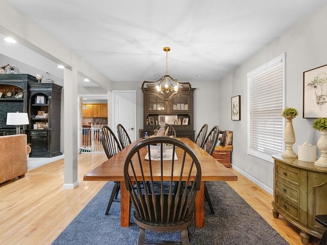 dining room featuring an inviting chandelier and light wood-type flooring