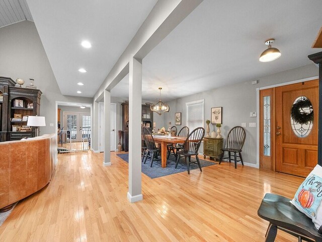 foyer featuring a notable chandelier, light hardwood / wood-style floors, and french doors