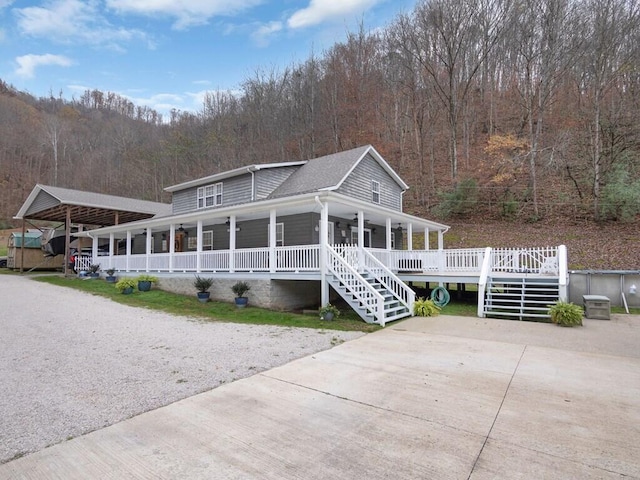 view of front of home with covered porch and a carport