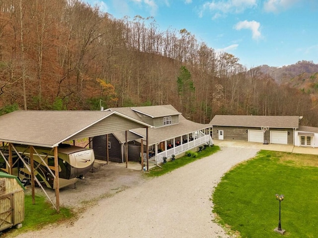 view of front facade with an outbuilding and a garage