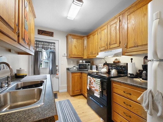 kitchen with sink, white fridge, light hardwood / wood-style floors, and black range with electric cooktop