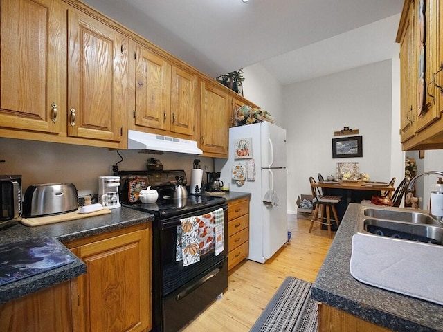 kitchen featuring electric range, sink, white fridge, and light wood-type flooring