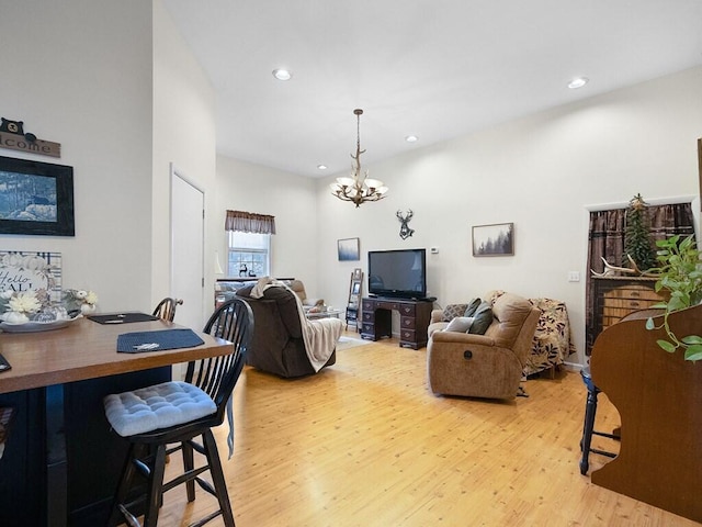 living room with light wood-type flooring and a notable chandelier