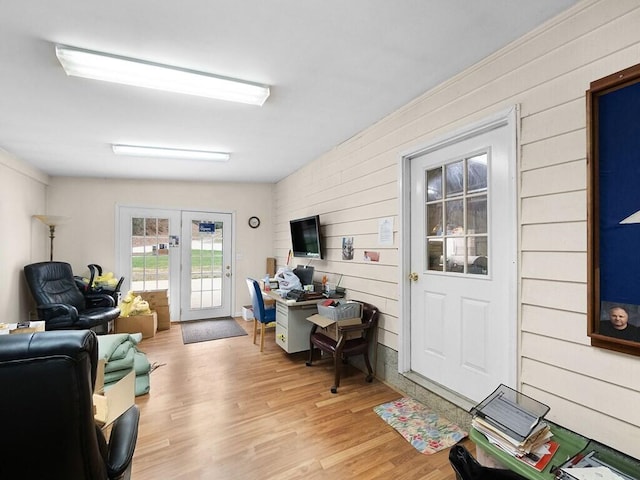 living room with french doors and light hardwood / wood-style flooring