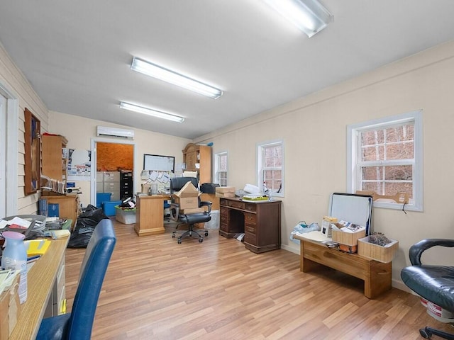 office space featuring light wood-type flooring and a wall mounted AC