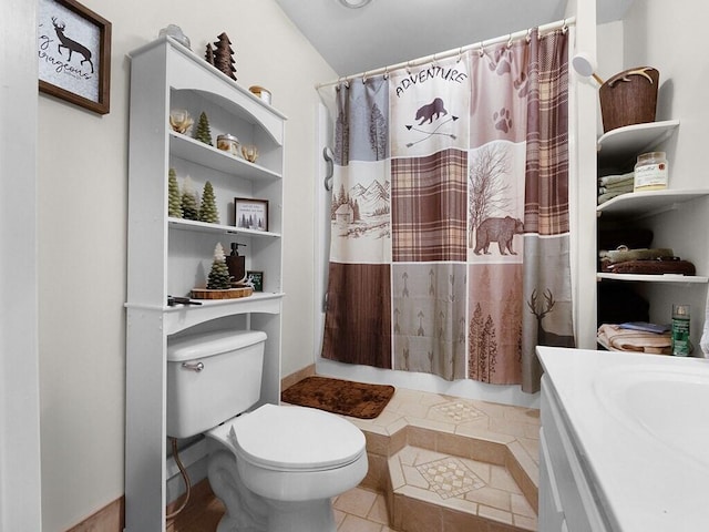 bathroom with tile patterned floors, vanity, curtained shower, and toilet