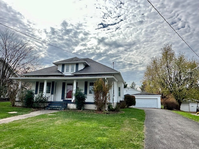 bungalow-style home with a porch, a front lawn, an outdoor structure, and a garage